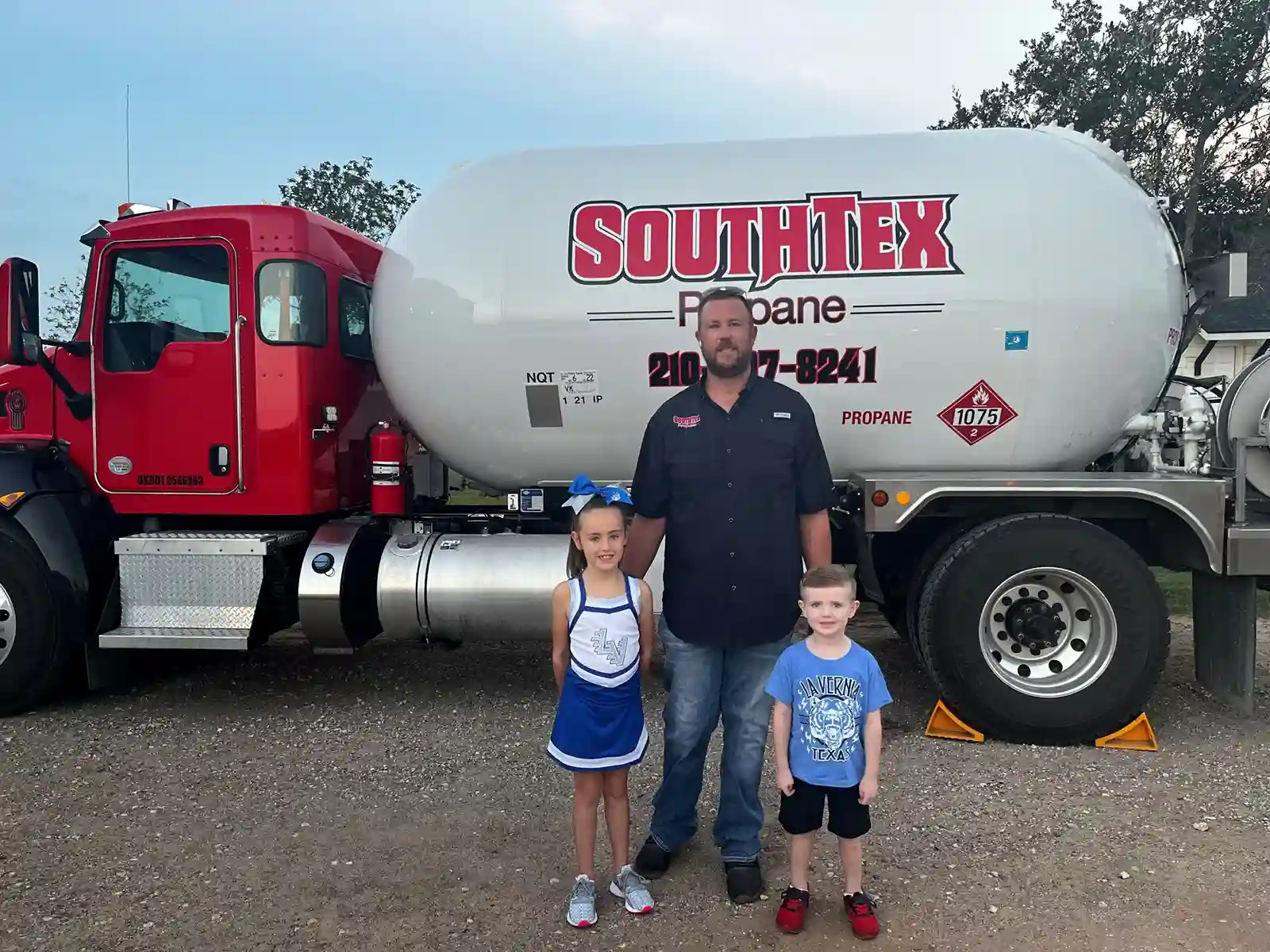 kids and men standing in front of truck